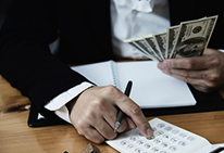 A calculator with money, illustrating deductibles as a premium factor.